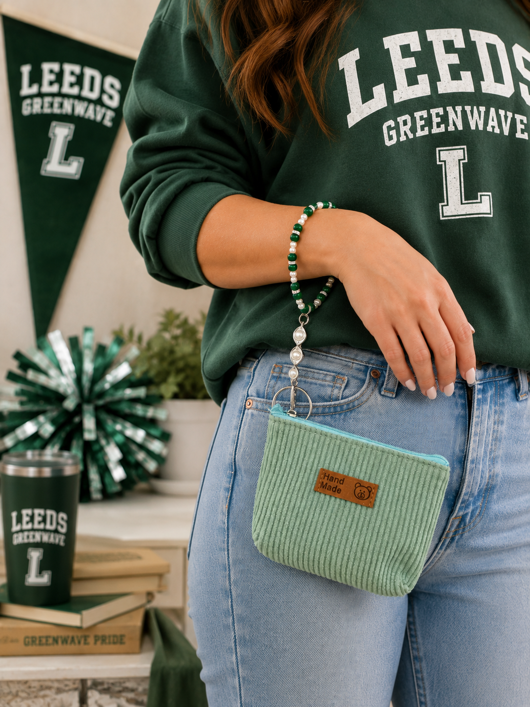 Green and white pearl wristlet keychain and mint pouch worn with green school spirit sweatshirt