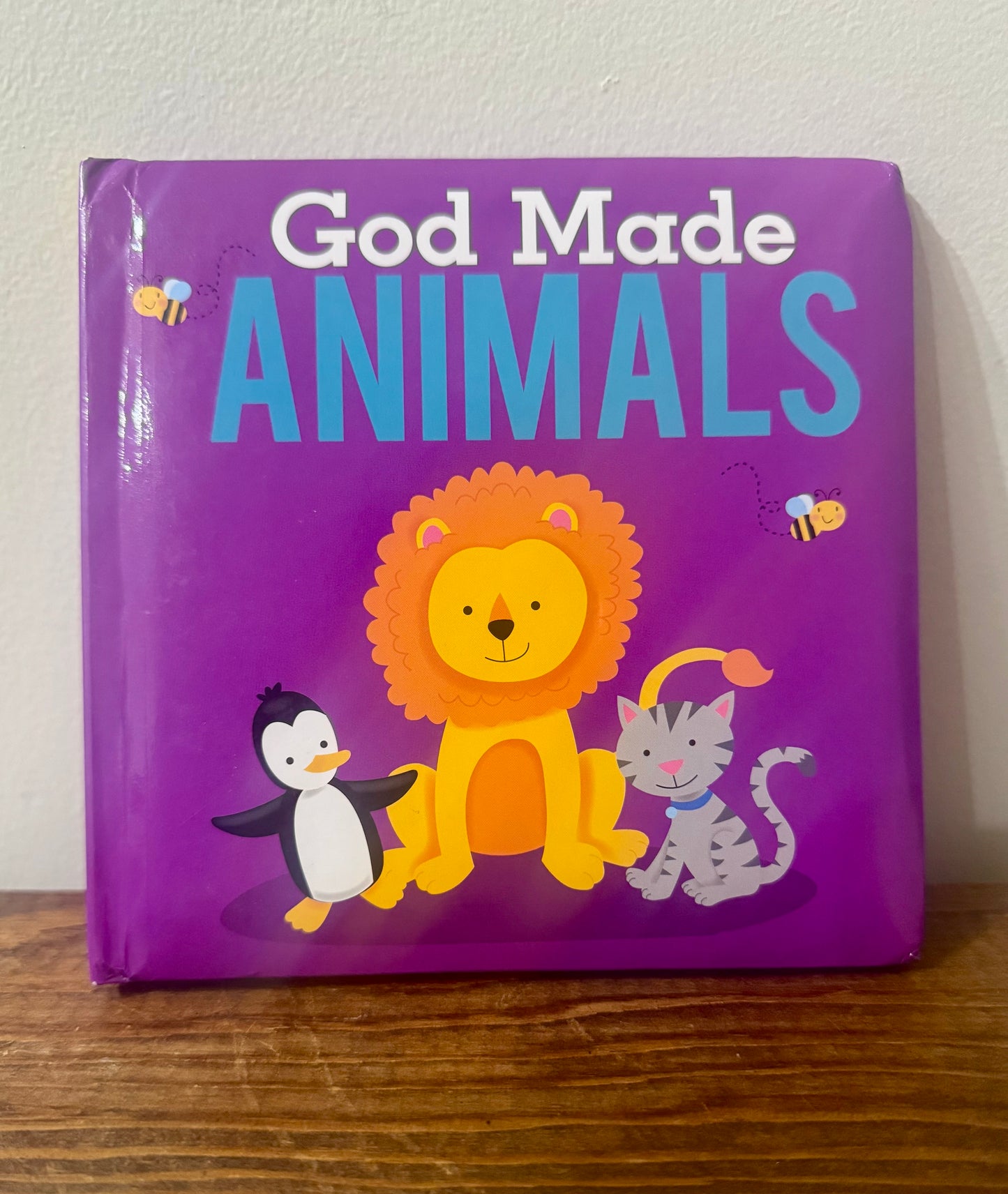 Cover of God Made Animals board book featuring various animals in a colorful setting