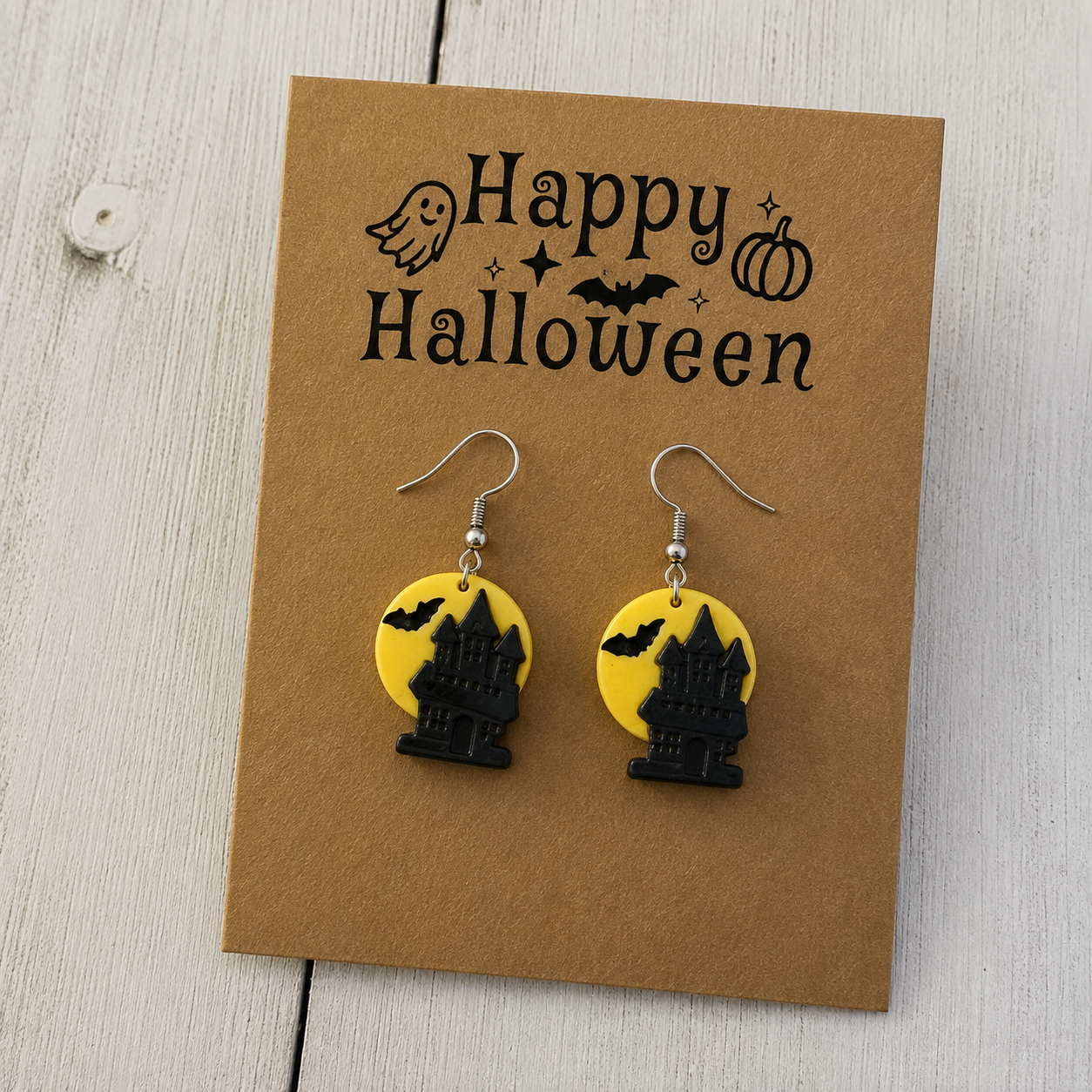Black haunted house and bat resin dangle earrings with yellow full moon design for Halloween