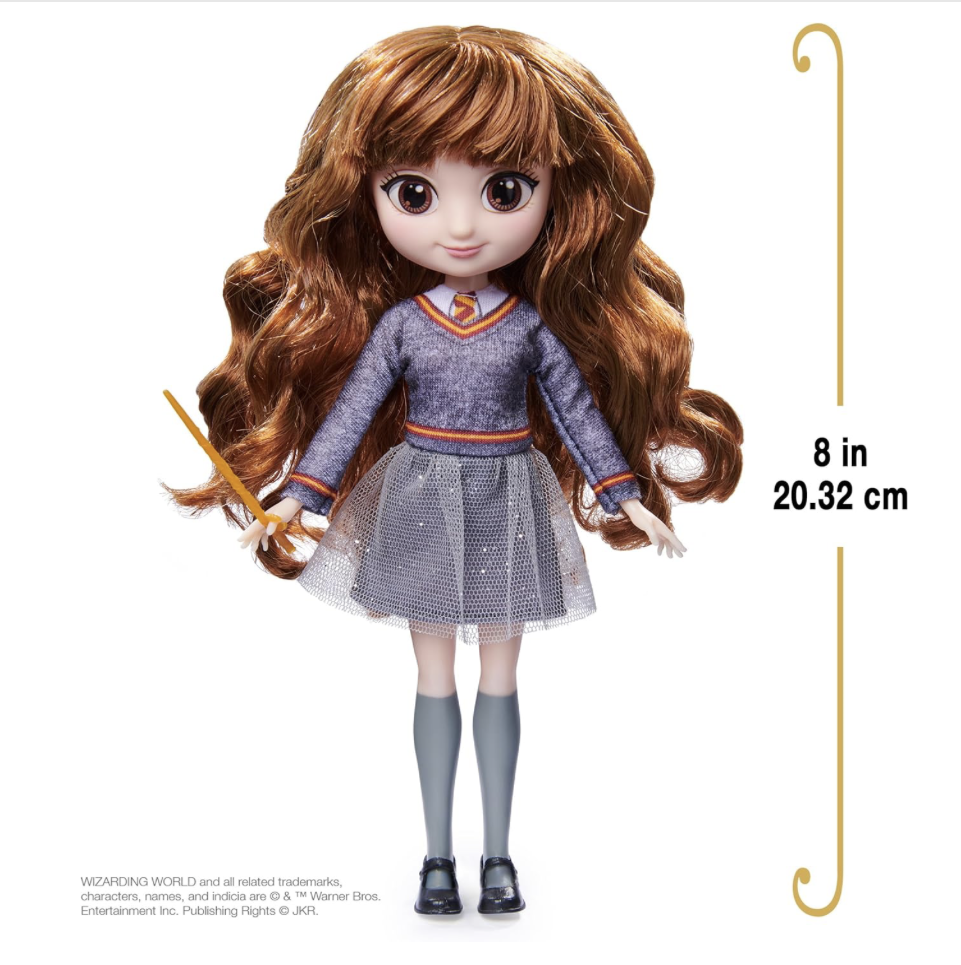 A Hermione Granger doll from the Wizarding World collection, dressed in a Hogwarts uniform and holding a wand, perfect for fans and collectors.