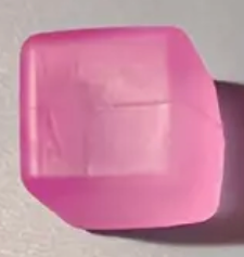 Pink cylindrical object on a gray background