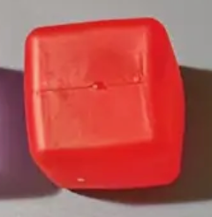 Close-up of a red button on a purple background