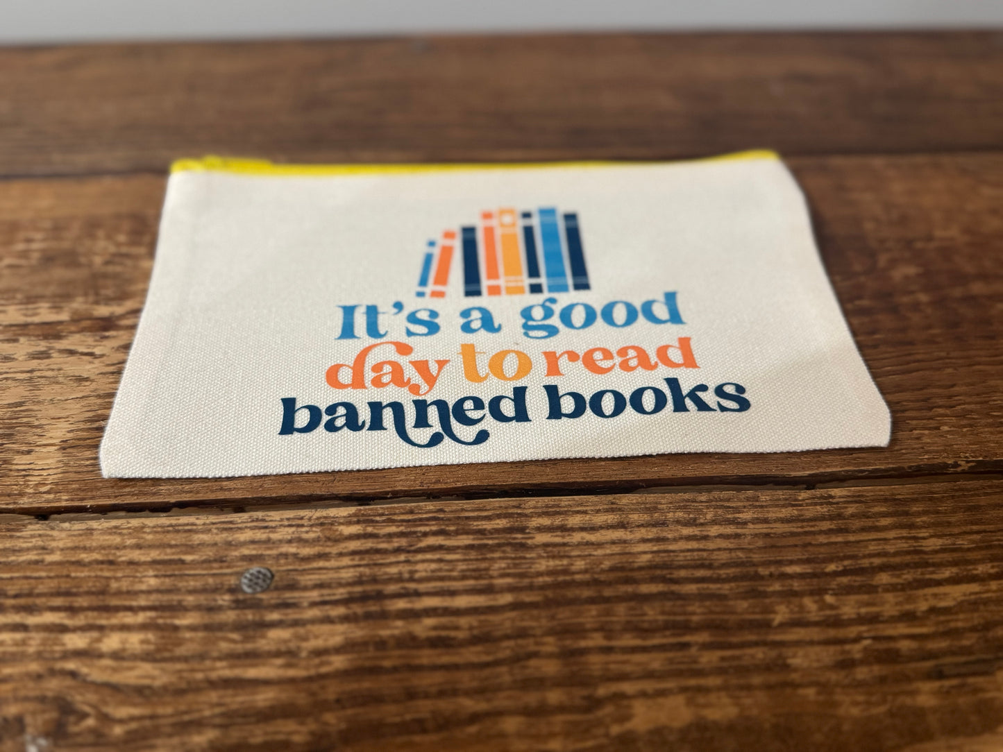 A stylish accessories bag featuring the phrase It's a Good Day to Read Banned Books in bold lettering. Perfect for book lovers, readers, and advocates of intellectual freedom.