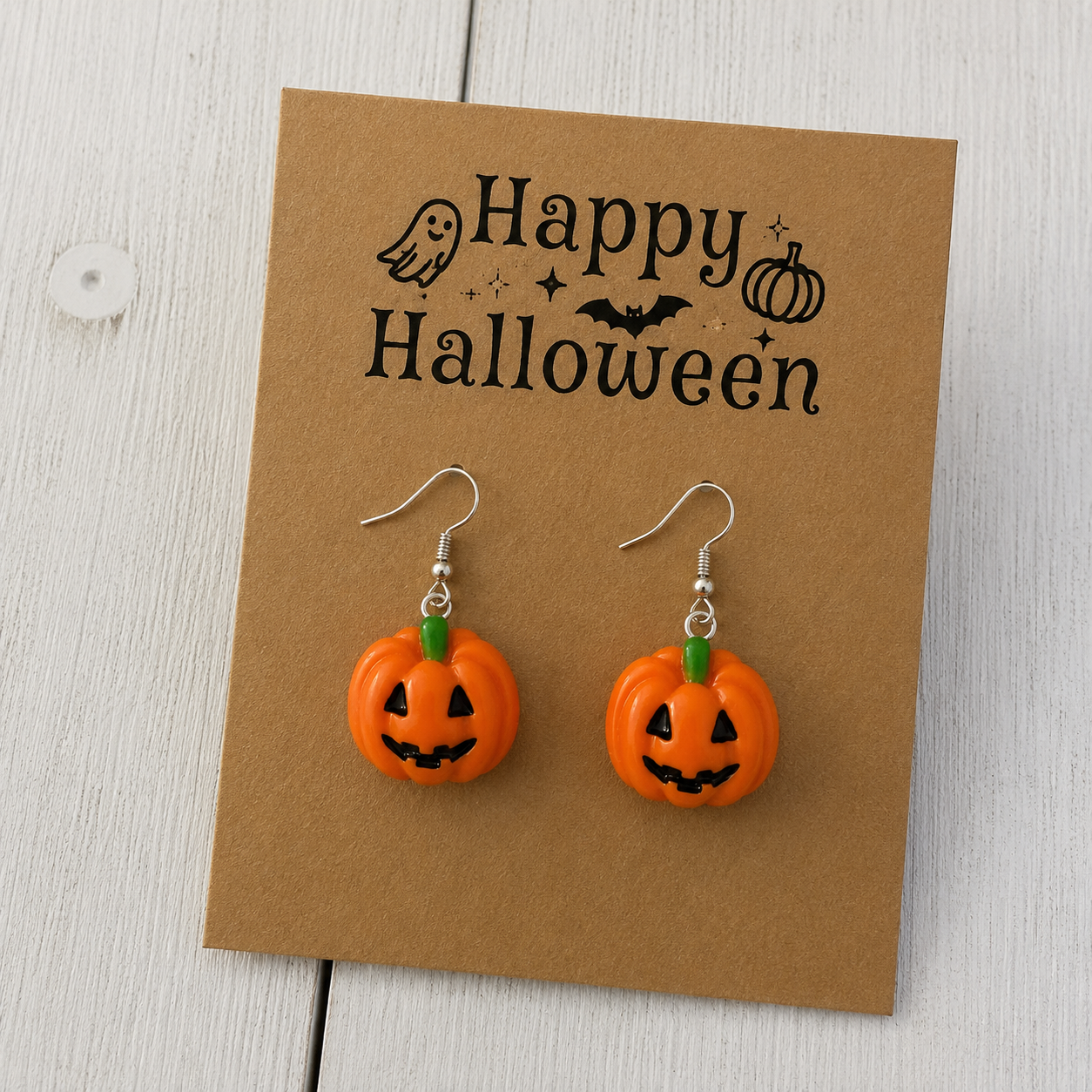 Orange jack-o’-lantern resin dangle earrings with green stems and silver-tone hooks for Halloween