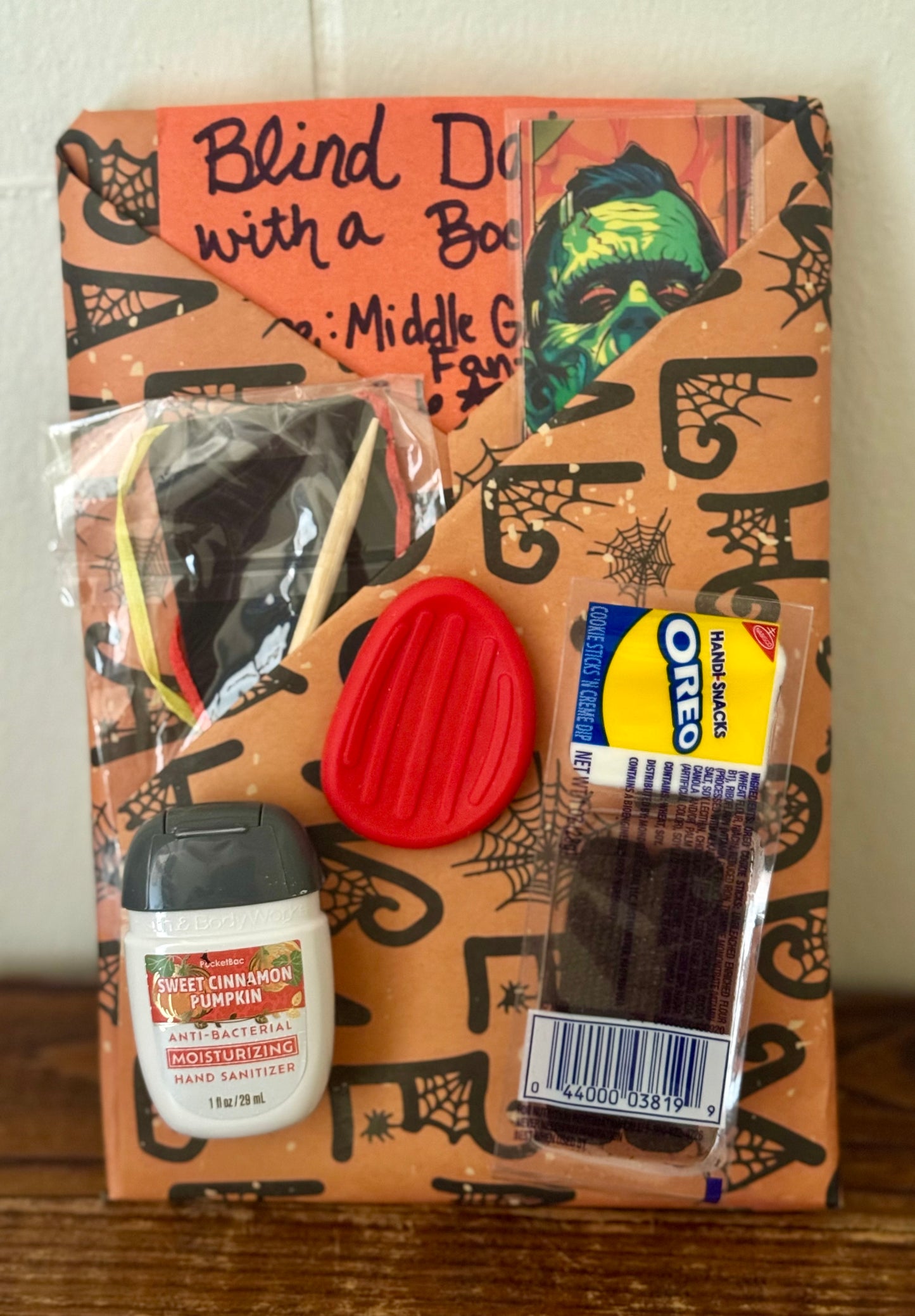 Halloween-themed snack bag with candy and a book inside