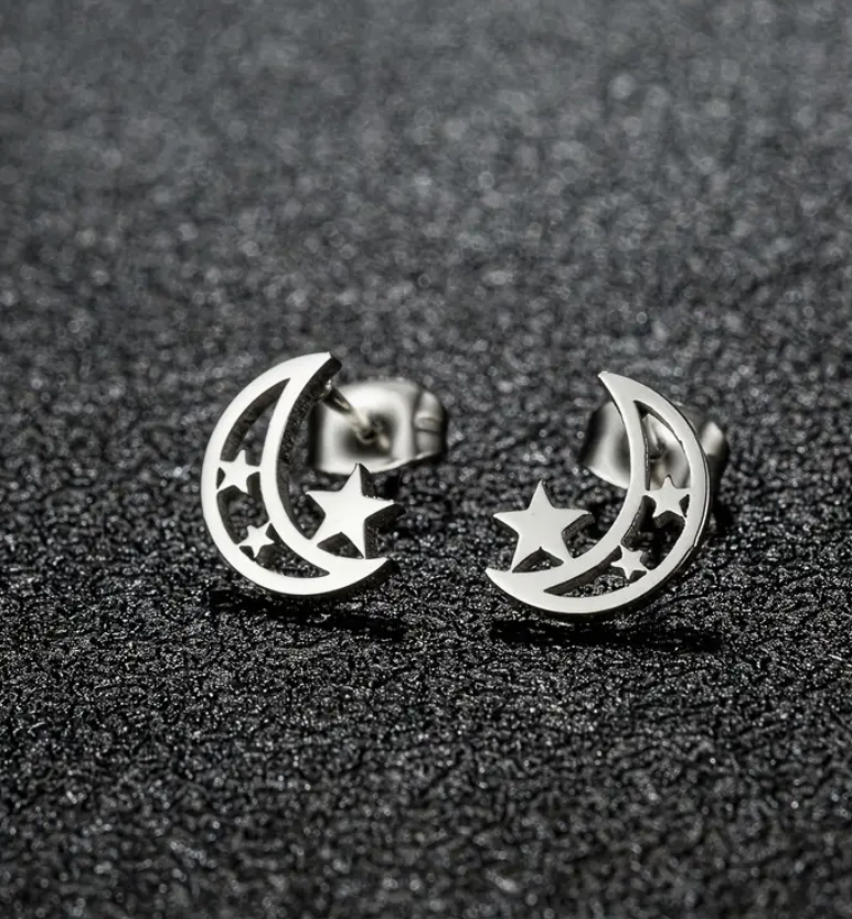 Pair of stainless steel moon and star stud earrings with a minimalist celestial design—perfect for everyday wear or space-inspired style.