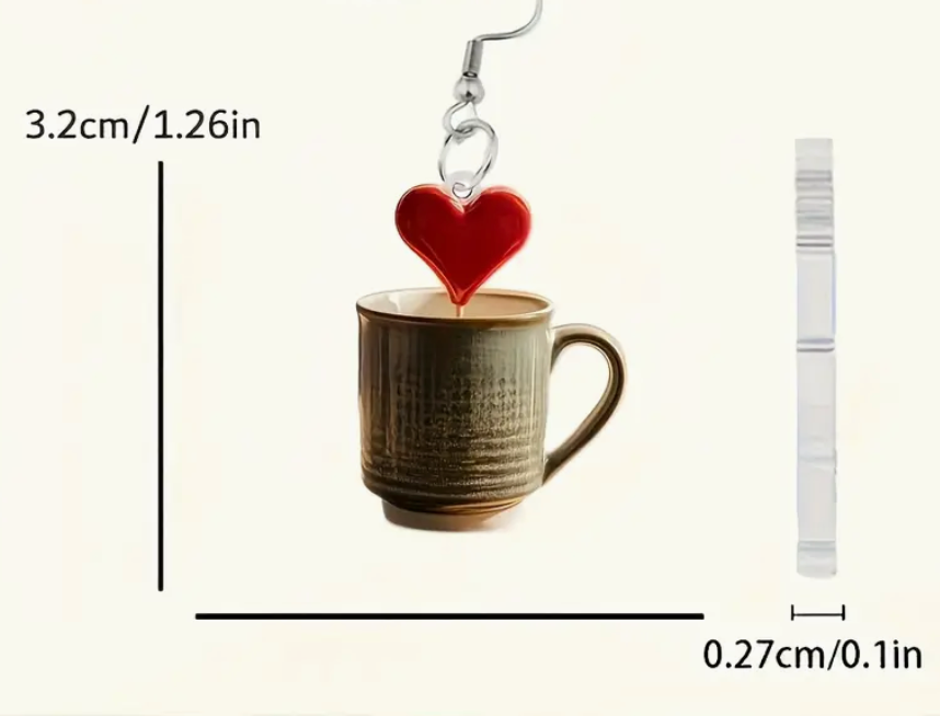 Acrylic earrings shaped like coffee mugs with heart-shaped foam art on top, perfect for coffee lovers and cozy accessory fans.