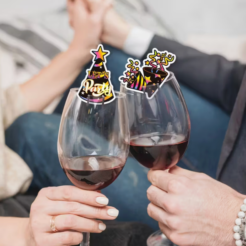 two people toasting with wine glasses decorated with festive new year party cutout markers
