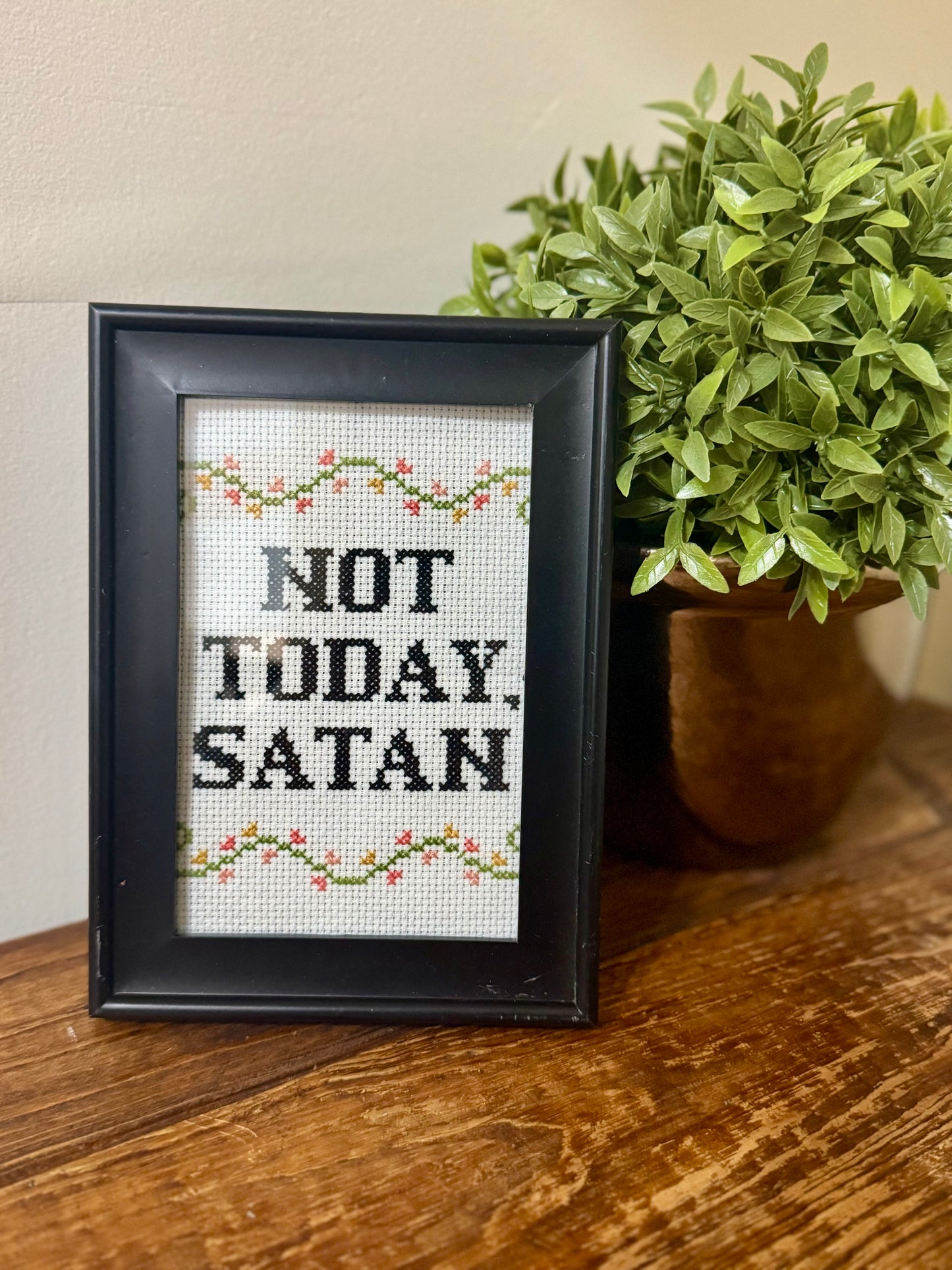 Framed 4x16 cross-stitch featuring the phrase Not Today Satan in hand-stitched embroidery.