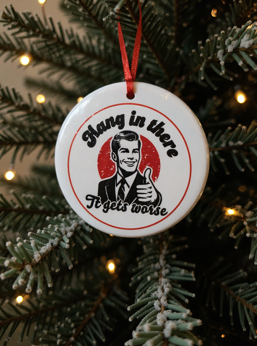 Retro funny ceramic ornament on Christmas tree that reads Hang in There It Gets Worse with vintage man illustration