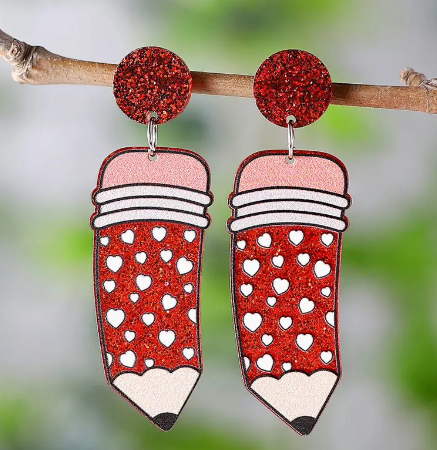 Pair of red acrylic pencil earrings featuring white heart accents, perfect for teachers and school-themed outfits.