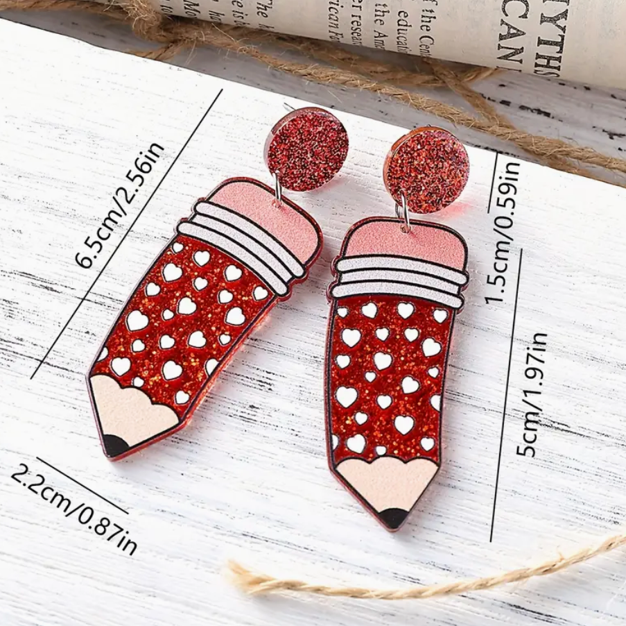 Pair of red acrylic pencil earrings featuring white heart accents, perfect for teachers and school-themed outfits.