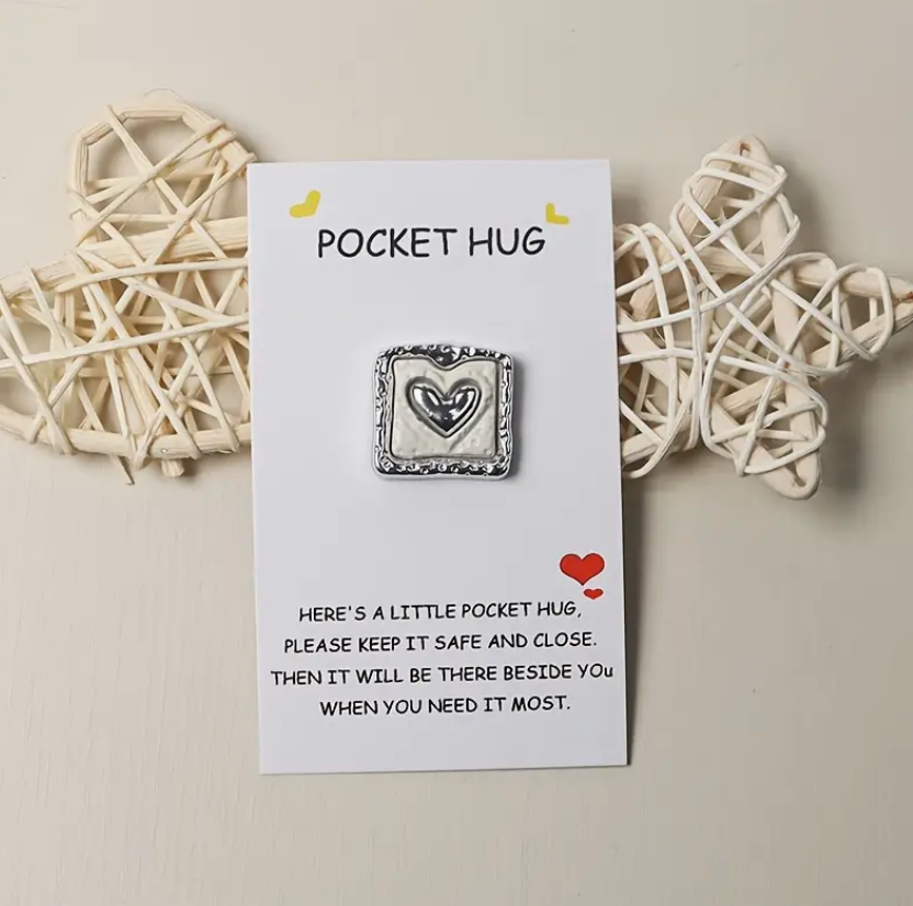 Silver heart-shaped pocket hug engraved with the message Here's a little pocket hug, please keep it safe and close. Then it will be there beside you when you need it most.