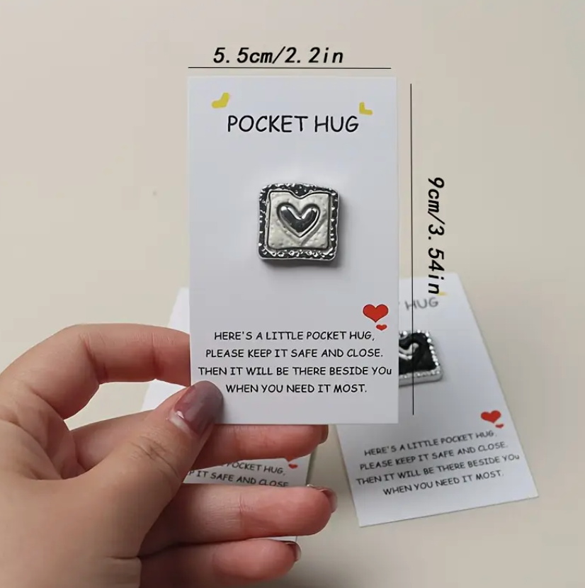 Silver heart-shaped pocket hug engraved with the message Here's a little pocket hug, please keep it safe and close. Then it will be there beside you when you need it most.