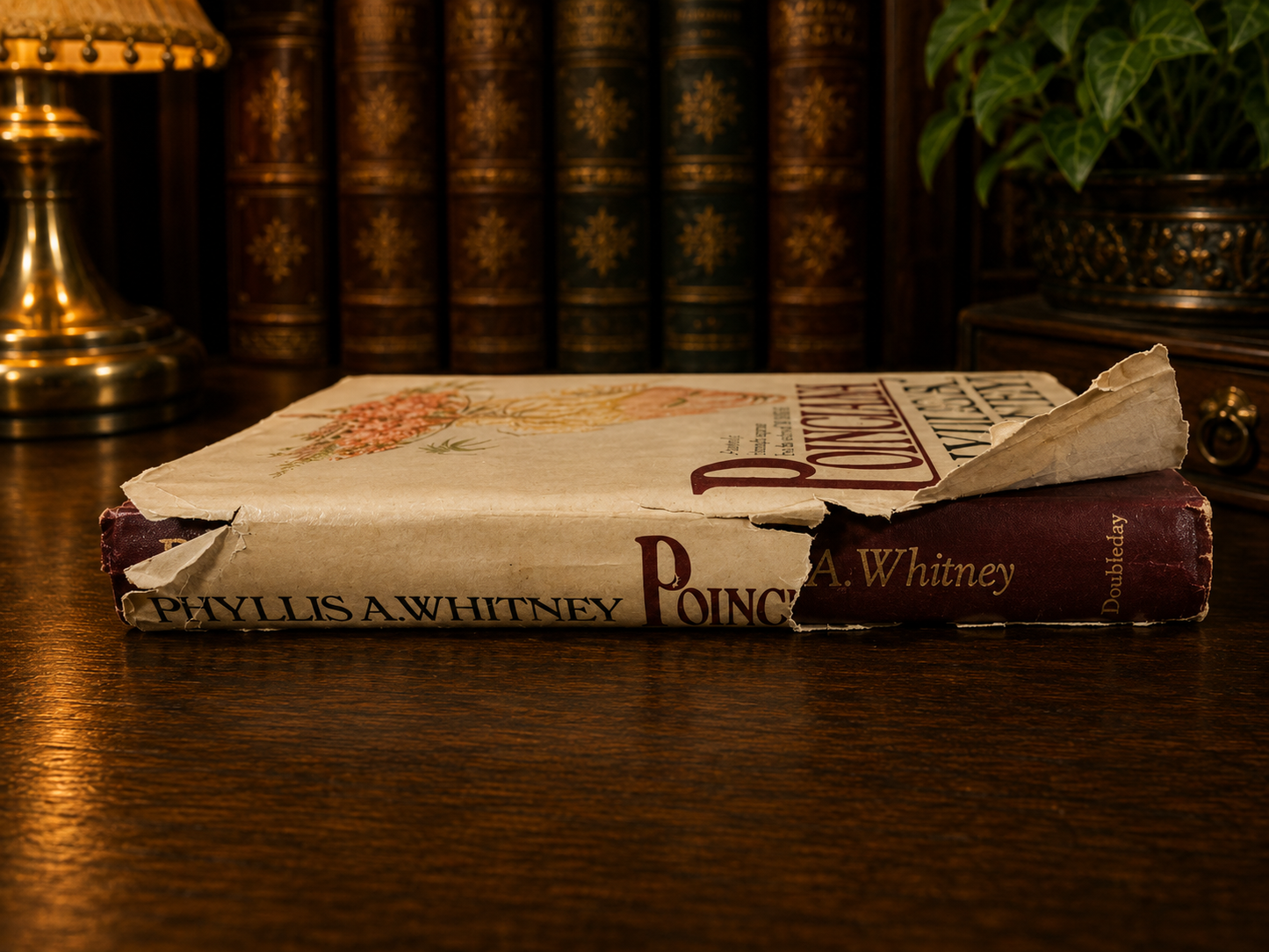 Side view showing dust jacket wear and spine condition of Poinciana hardcover.