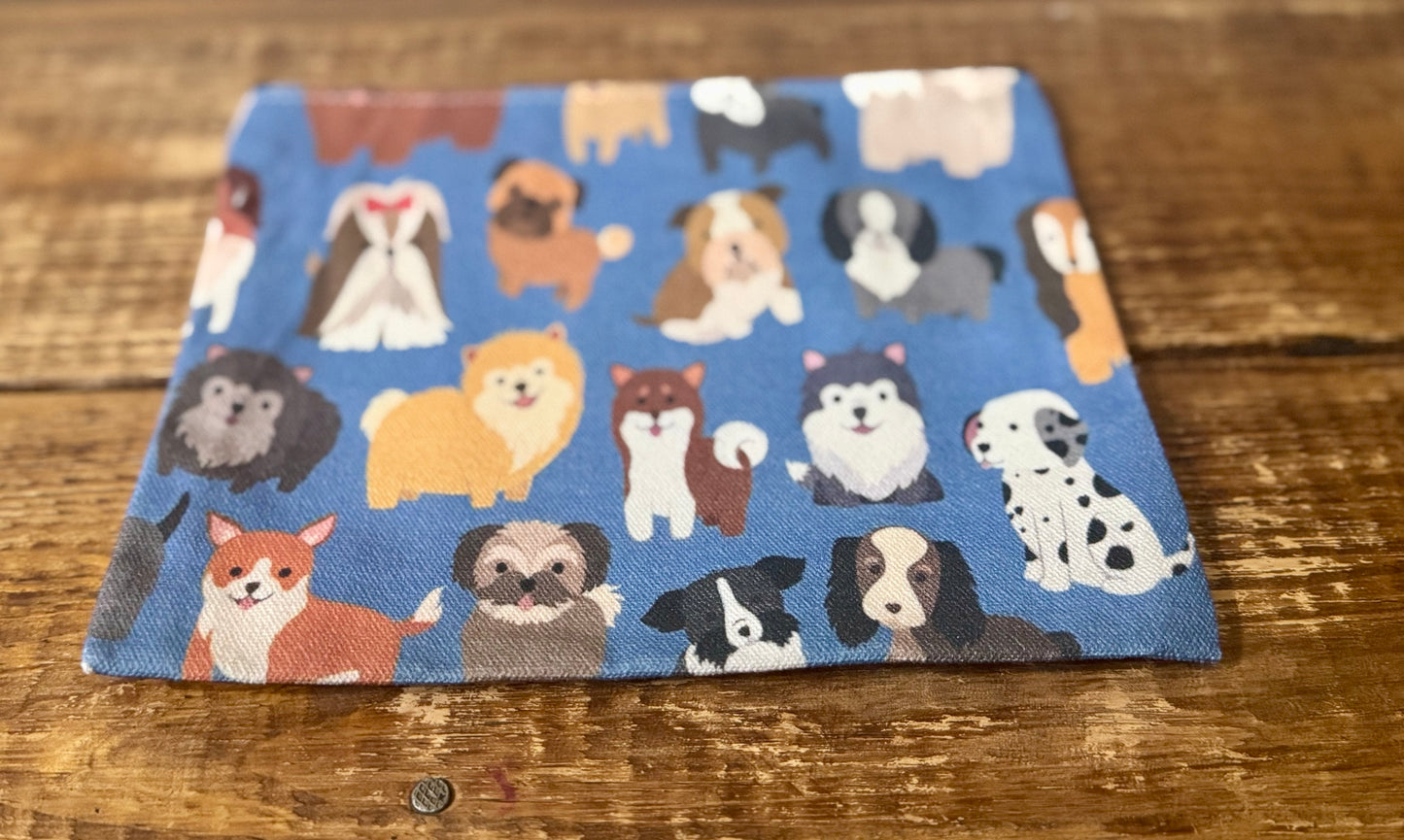 A 7"x8.5" accessories pouch featuring a playful all-over print of dogs, perfect for pet lovers and dog enthusiasts.