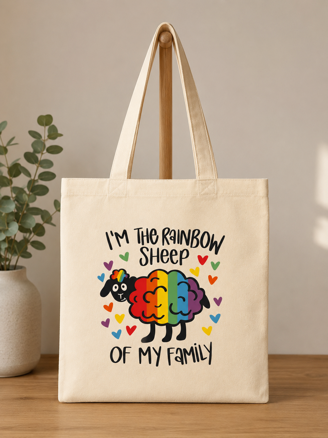 Canvas reusable shopping tote bag featuring a rainbow sheep and the phrase I’m the Rainbow Sheep of My Family surrounded by colorful hearts