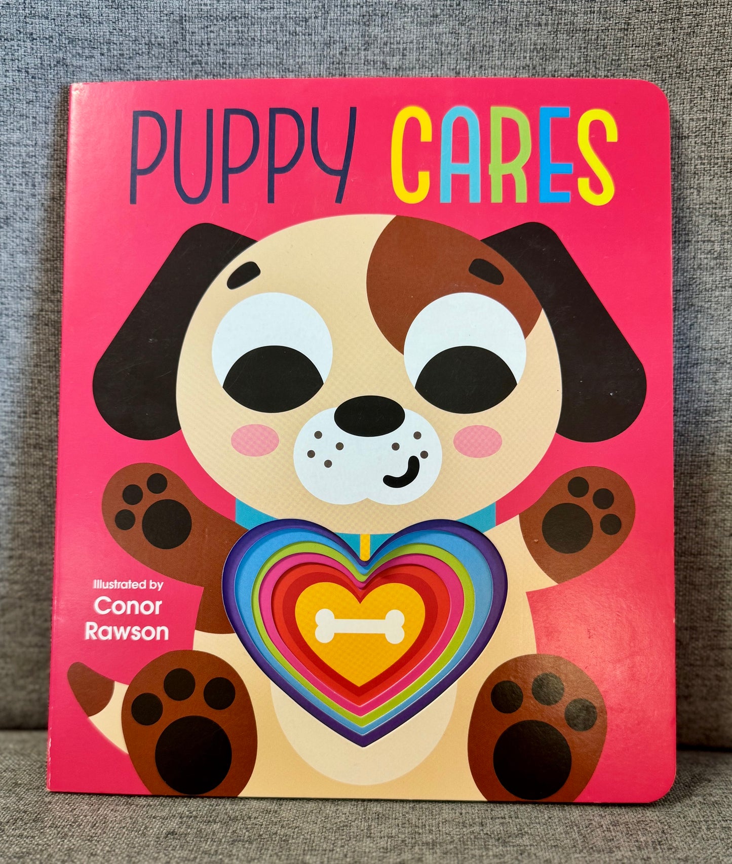 Cover of Puppy Cares by Conor Rawson, featuring an illustration of a playful puppy engaging with various objects.
