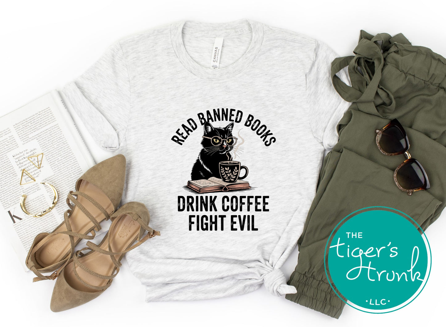 White t-shirt with cat graphic and text, paired with green pants, sunglasses, and shoes on a white background.