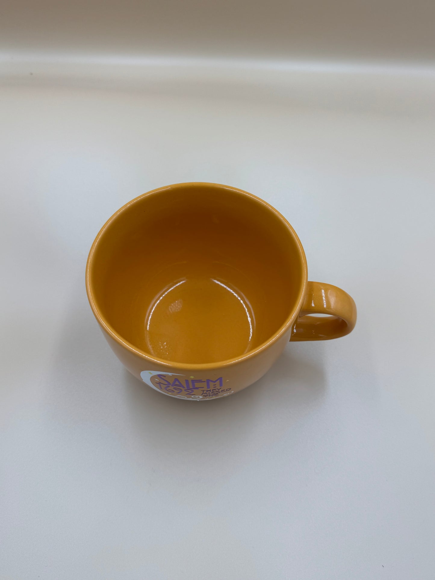 Brown mug with a logo on a white background