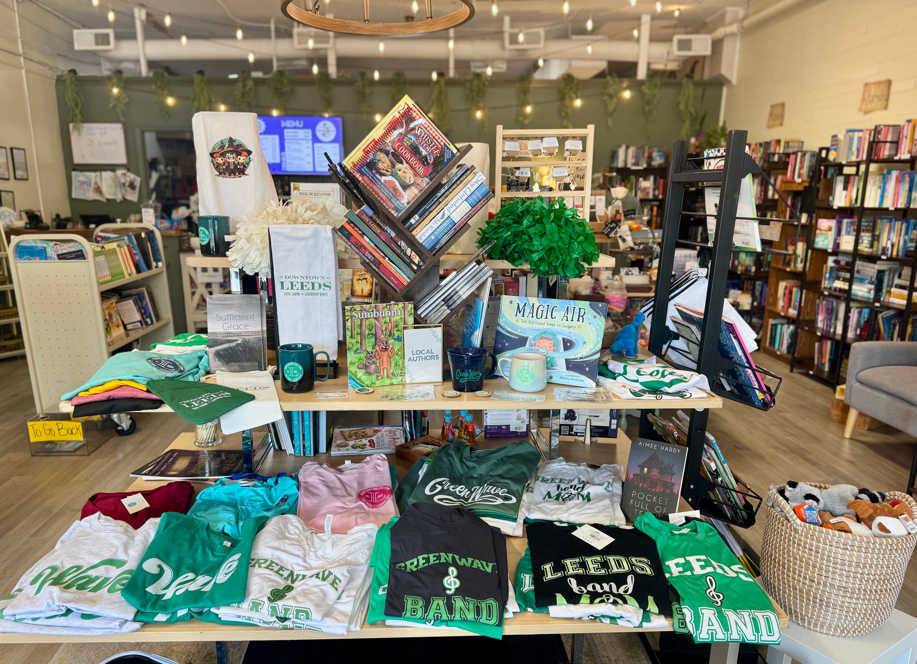 Display of t-shirts and books in a store with a casual atmosphere