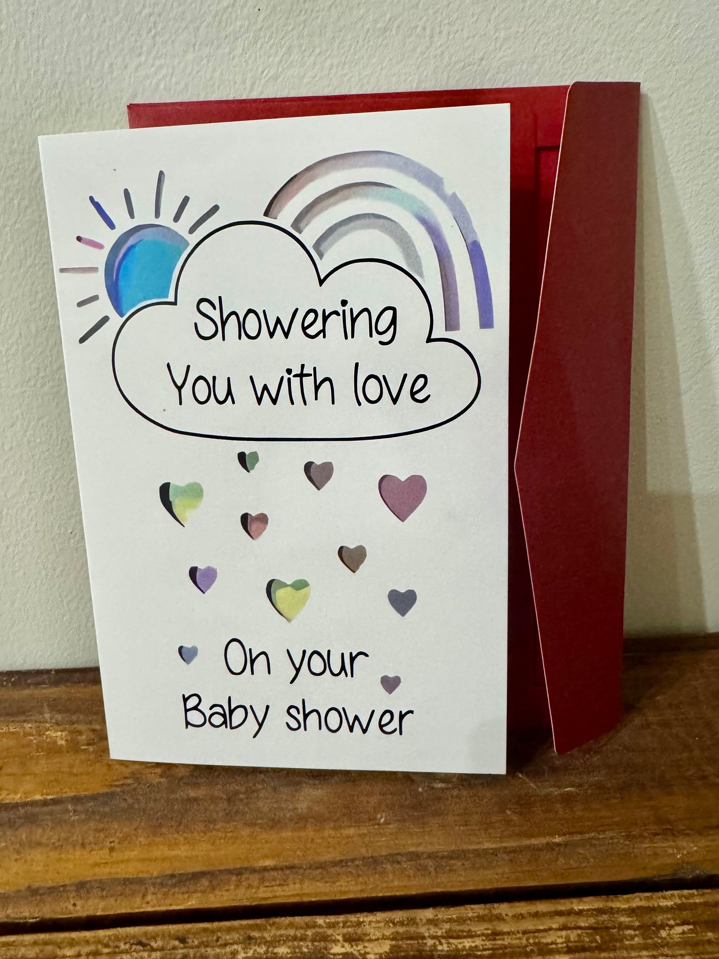 Greeting card with the message "Showering You with Love on Your Baby Shower," perfect for celebrating new parents.