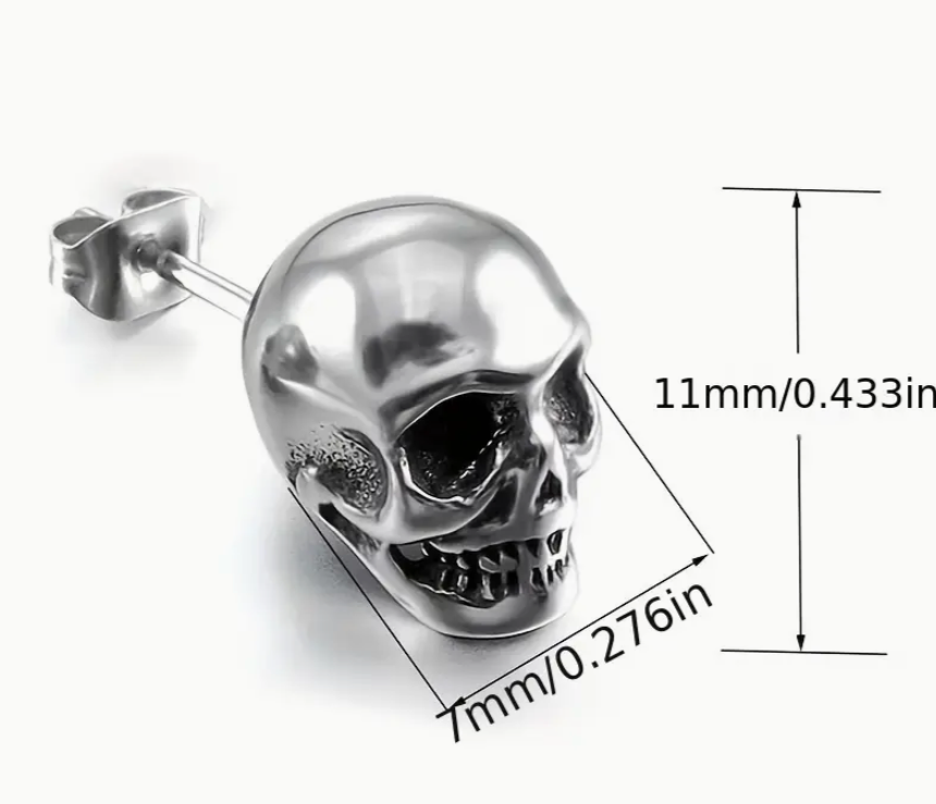 Silver skull-shaped earring with measurements on a white background