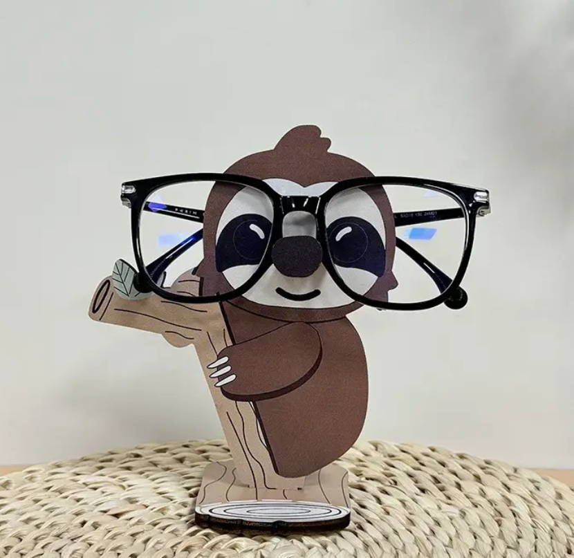 Sloth-shaped eyeglass holder stand displaying a pair of glasses.