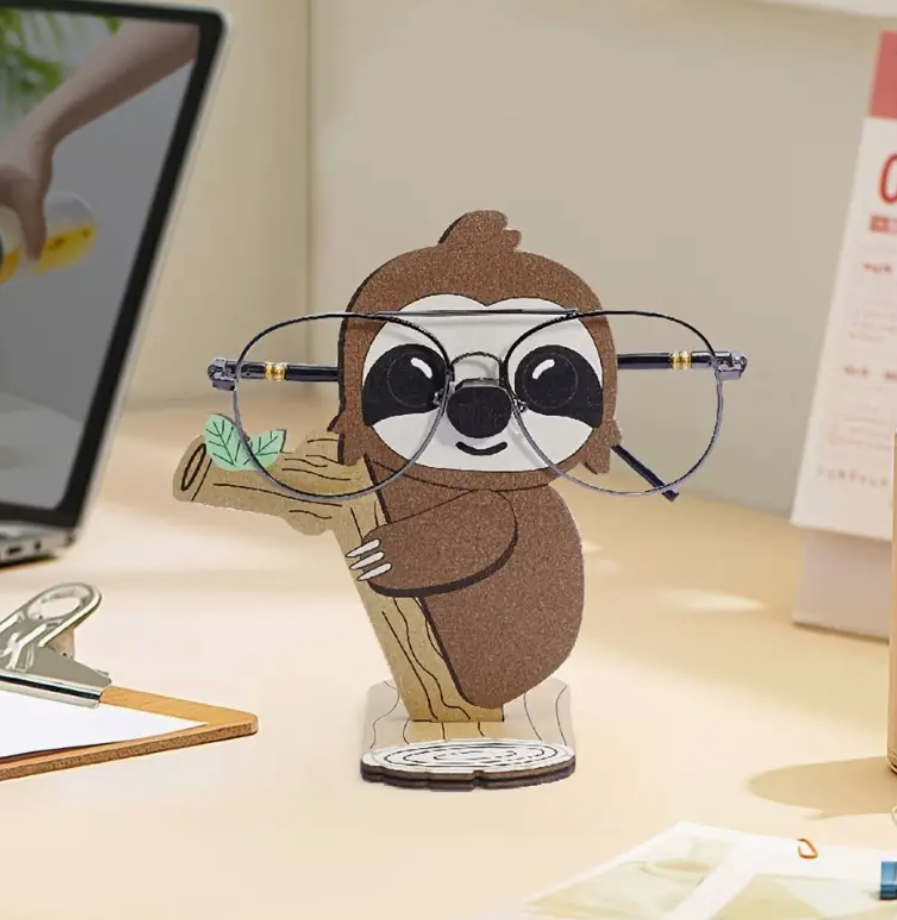 Sloth-shaped eyeglass holder stand displaying a pair of glasses.