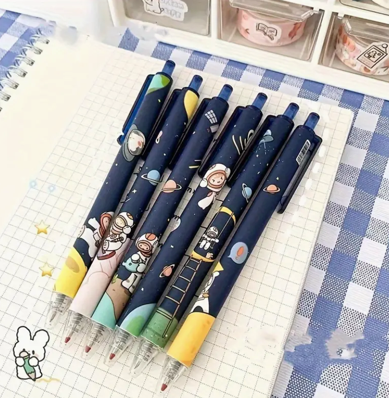 A fine point 0.5mm gel pen with quick-drying black ink, featuring a fun space-themed design with rockets, planets, and stars.