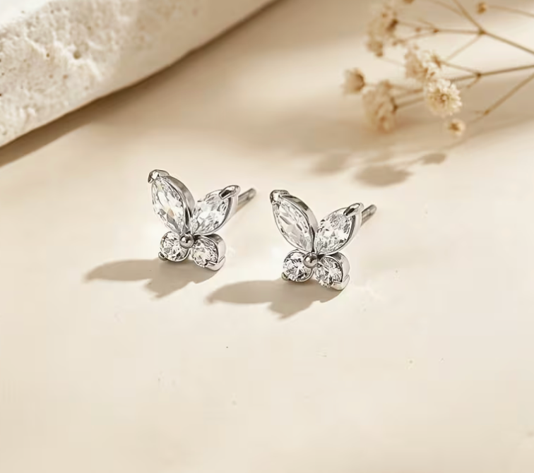 Silver-tone butterfly stud earrings with sparkling clear faceted crystal-style stones