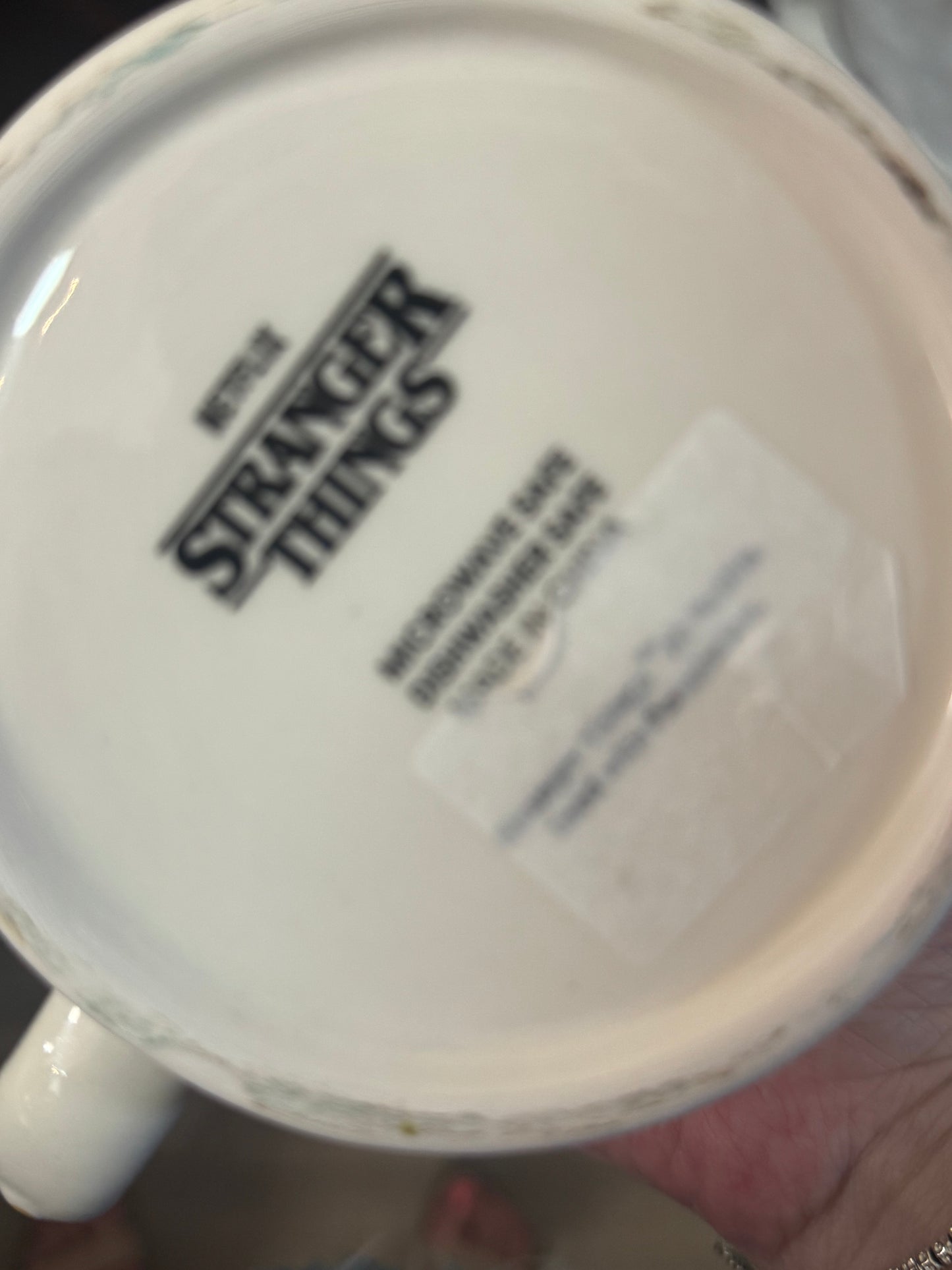 Mug with 'Stranger Things' branding on a white background