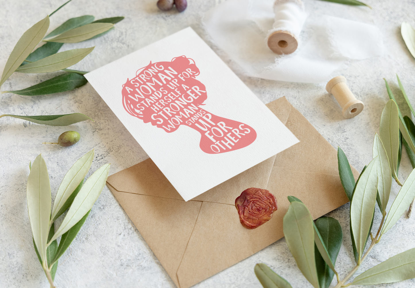 A Women’s History Month greeting card featuring the silhouette of a woman’s head and the empowering quote: A strong woman stands up for herself. A stronger woman stands up for others.