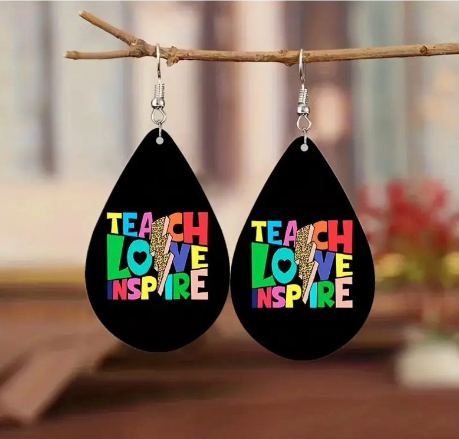 Pair of wooden teardrop earrings with a lightning bolt design and the phrase Teach Love Inspire, perfect for teachers who bring energy and heart to the classroom.