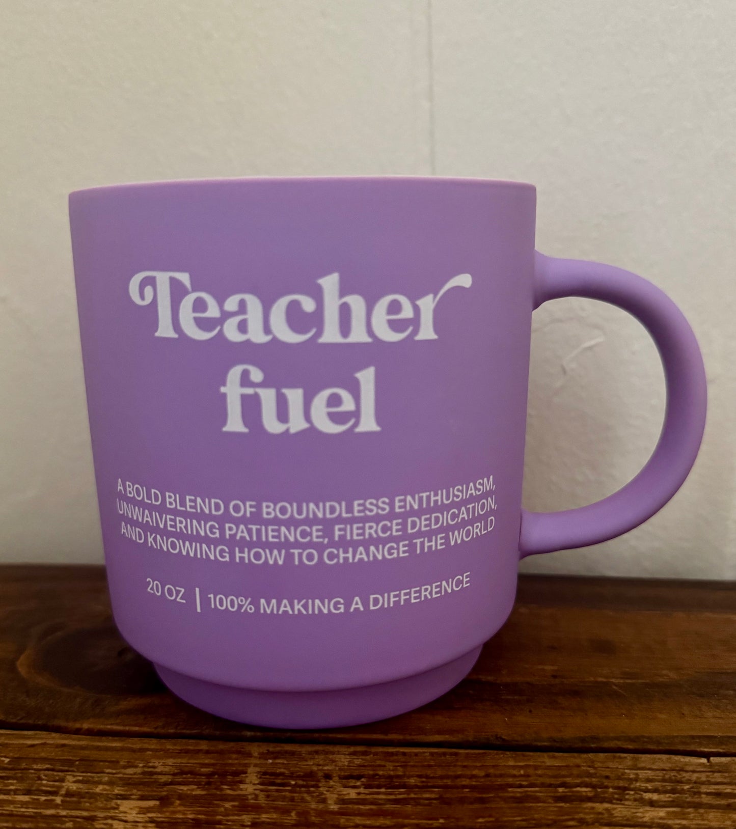 Lavender ceramic mug with white text that reads Teacher Fuel and a message about educator dedication and impact