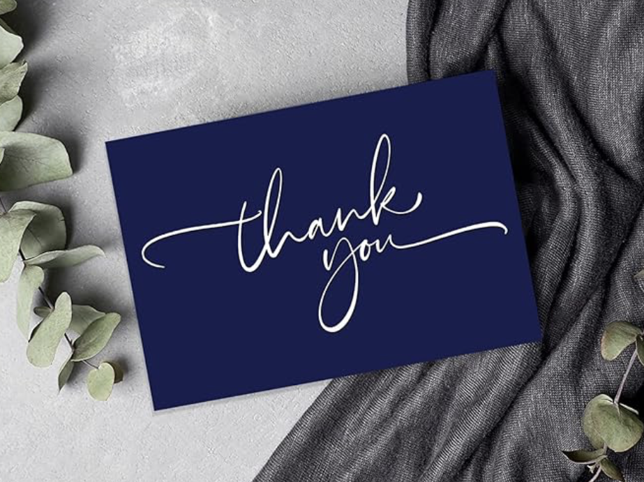 A simple and elegant "Thank You" greeting card, accompanied by an envelope and two decorative stickers.