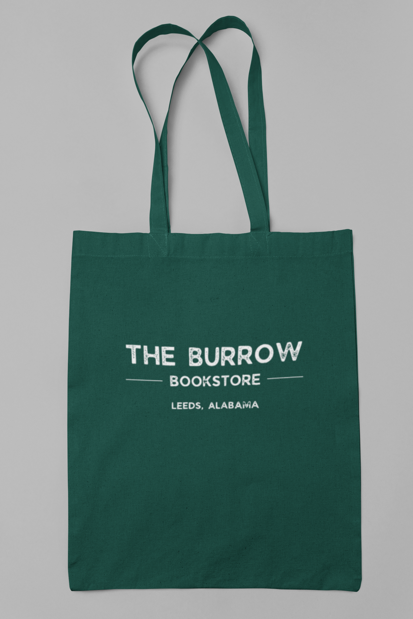Canvas tote bags featuring The Burrow Bookstore logo on one side and various literary quotes on the other side.