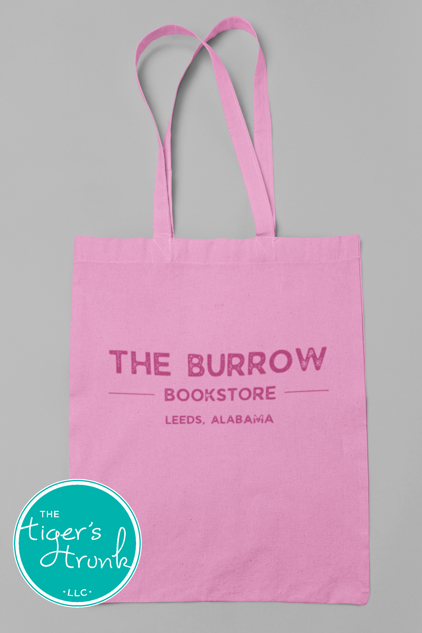 Canvas tote bags featuring The Burrow Bookstore logo on one side and various literary quotes on the other side.