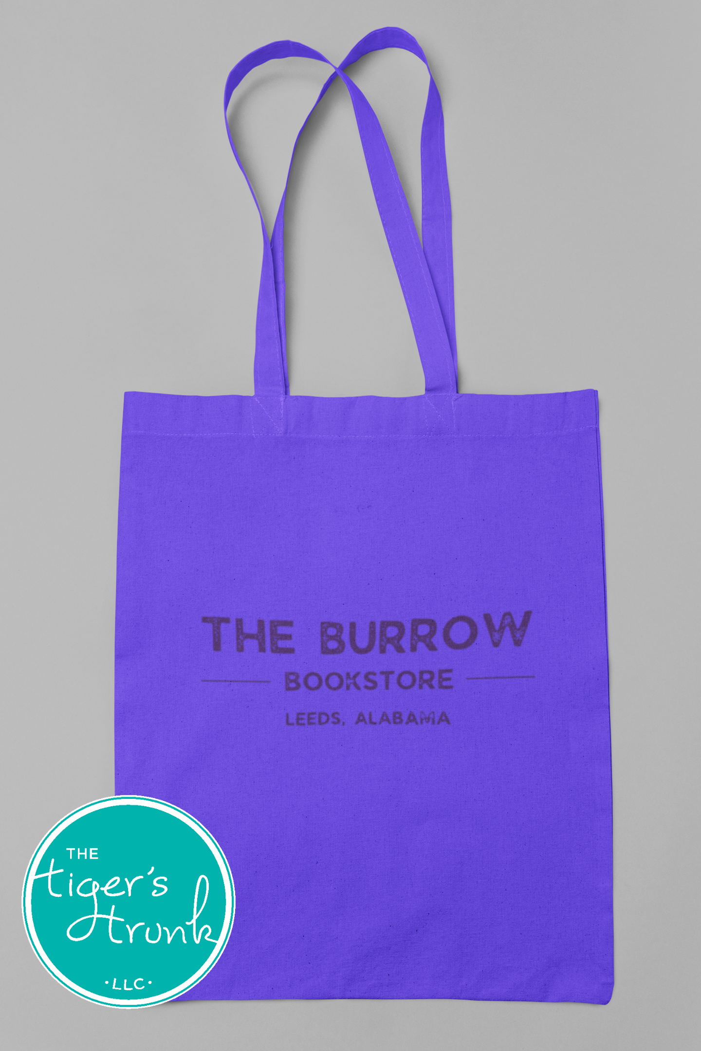 Canvas tote bags featuring The Burrow Bookstore logo on one side and various literary quotes on the other side.