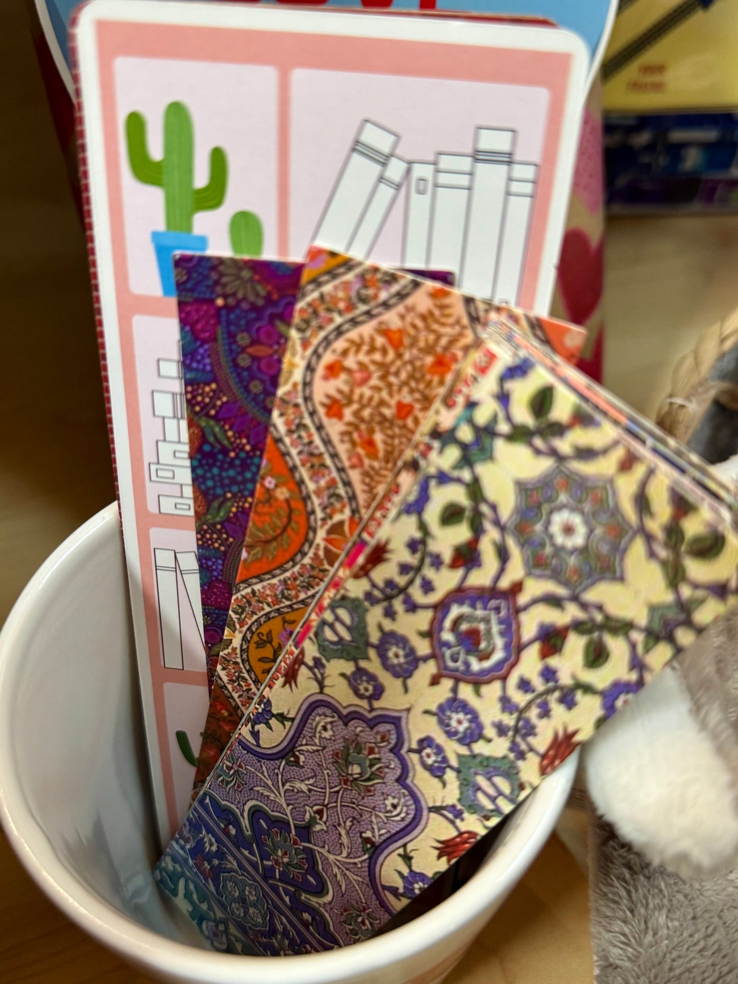 A variety of colorful bookmarks in assorted designs, laid out on a table, perfect for book lovers.