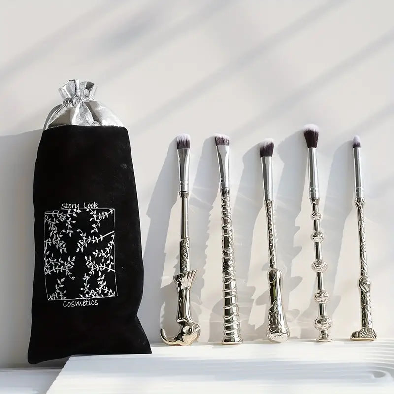 Set of makeup brushes with handles designed to resemble wizard wands, featuring intricate detailing and soft bristles.