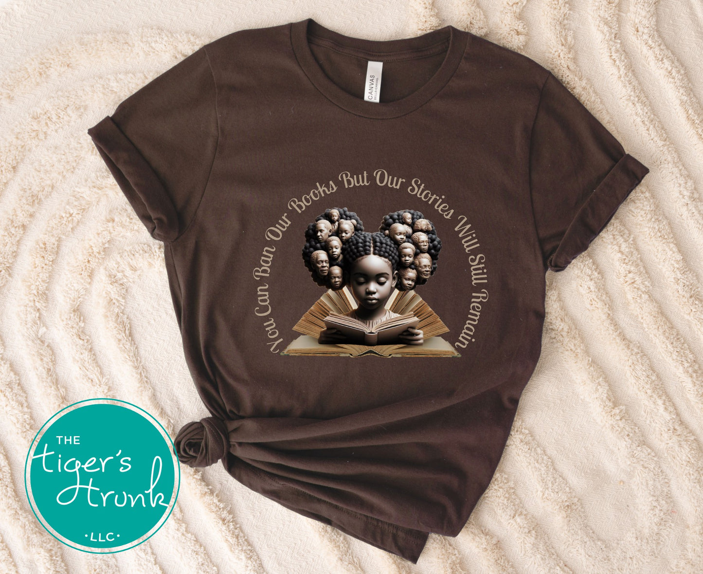 Brown t-shirt with a graphic of a girl reading a book and text on a textured surface, featuring 'The Tiger's Horn'.