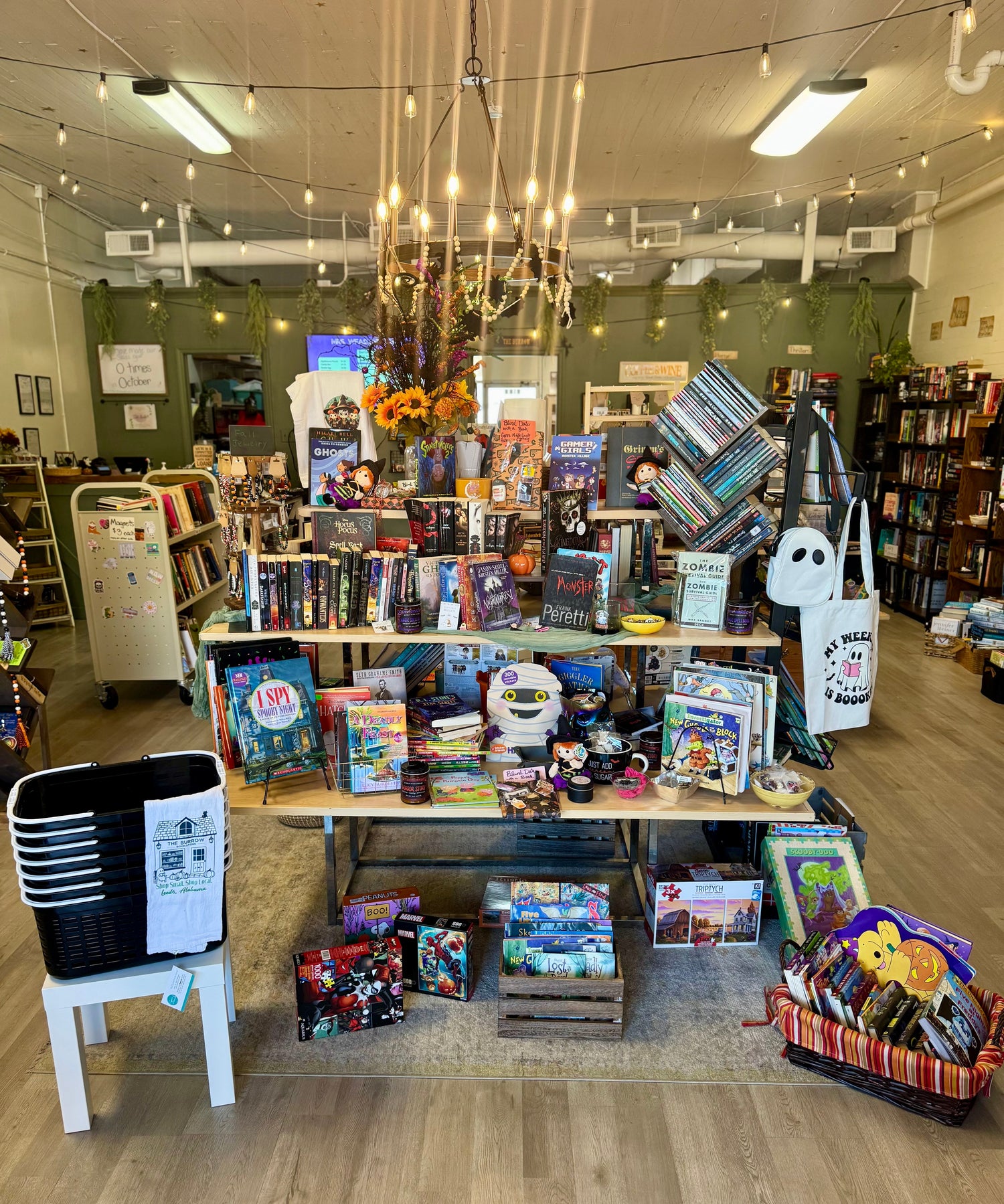 A playful Halloween-themed bookstore display featuring spooky children’s books, pumpkin décor, and warm seasonal lighting.