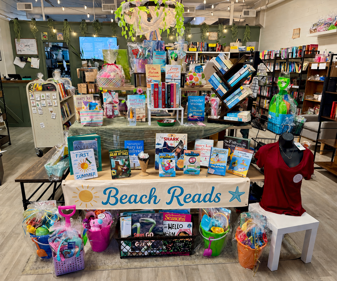 A bright, cheerful seasonal display featuring spring and summer children’s books, colorful décor, and sunny, warm-weather accents.