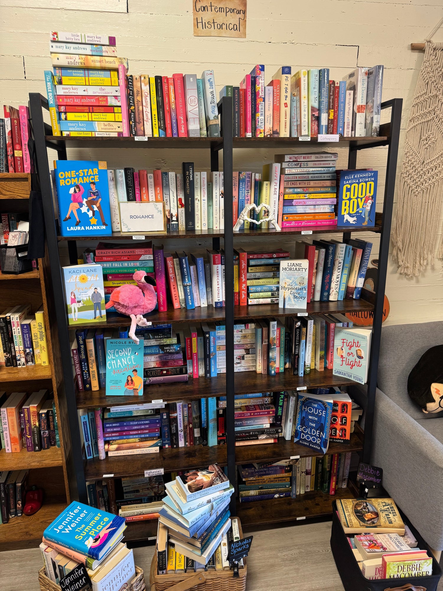 A softly lit bookstore display featuring historical romance novels with elegant covers, lace or floral décor, vintage props, and candles for a timeless, romantic feel.