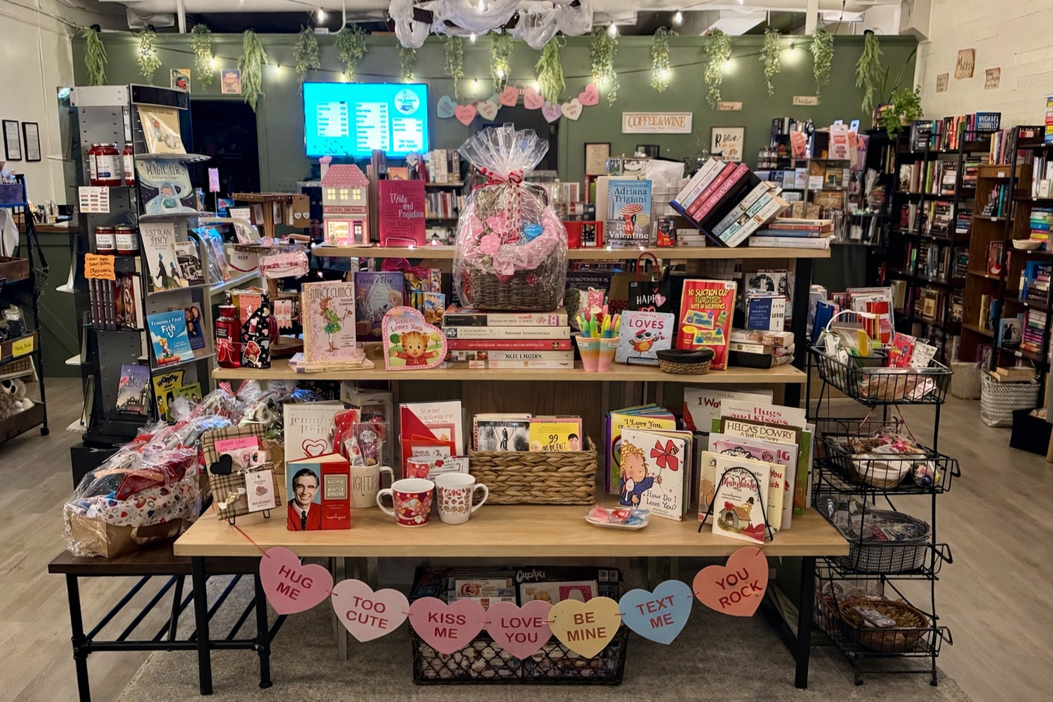 A bright Valentine’s Day display featuring pink and red children’s books, heart-themed gifts, and cheerful seasonal décor.