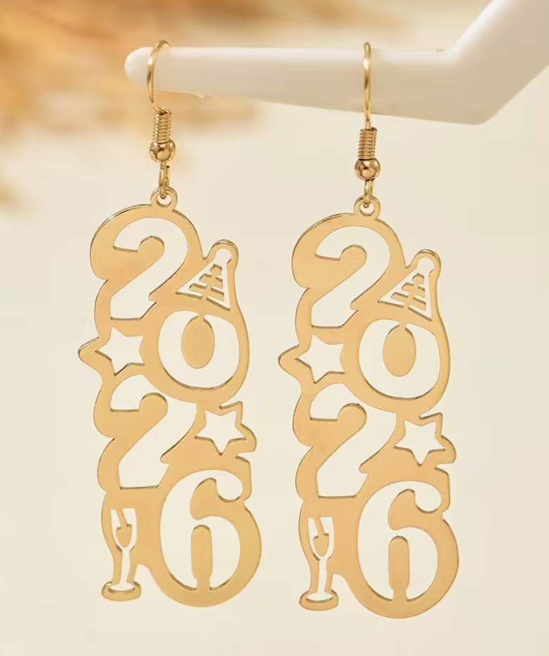 Gold 2026 number earrings hanging from display stand
