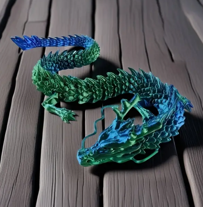 Green and blue dragon sculpture on a wooden surface