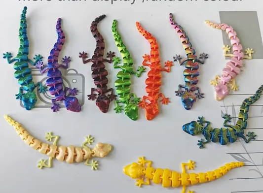 Colorful toy lizards on a white surface with a grid pattern