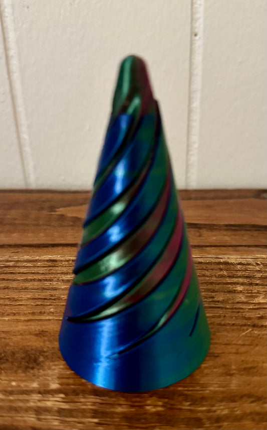 Colorful striped cone-shaped object on a wooden surface